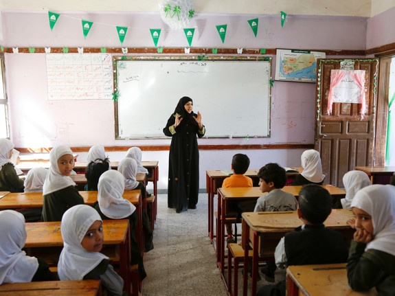 En kvinnlig lärare står framför sina elever.